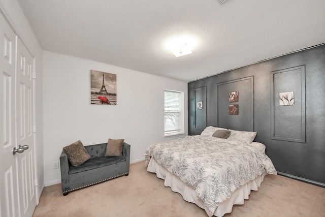 bedroom featuring baseboards and light colored carpet