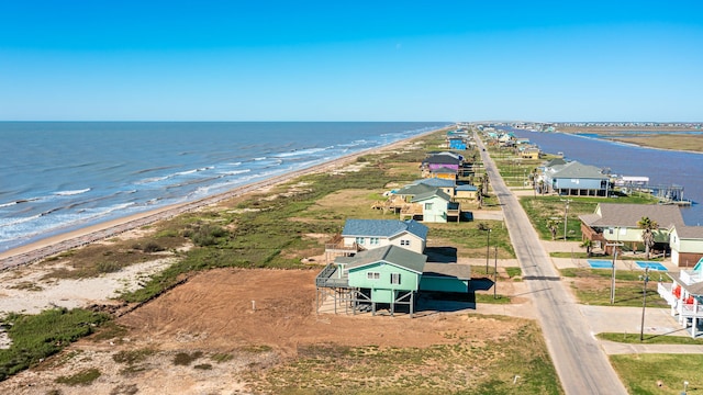 bird's eye view with a water view and a beach view