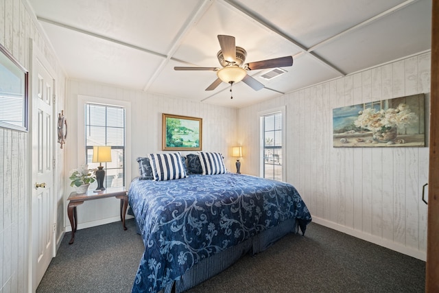 carpeted bedroom with a ceiling fan, baseboards, and visible vents