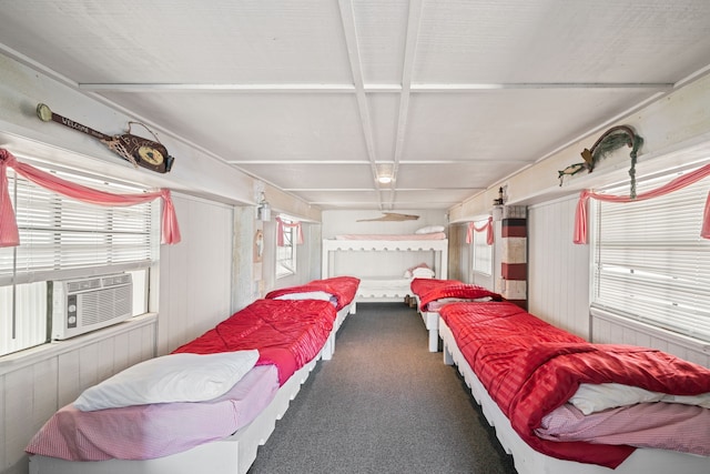 bedroom featuring carpet flooring, wood walls, and cooling unit