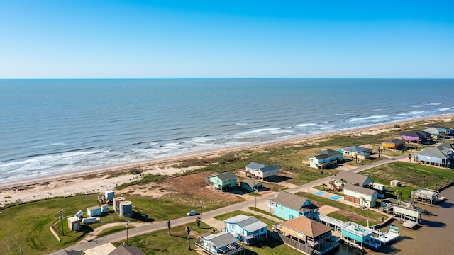 drone / aerial view featuring a water view and a beach view