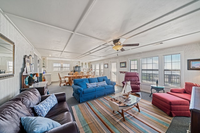 carpeted living room featuring visible vents and a ceiling fan