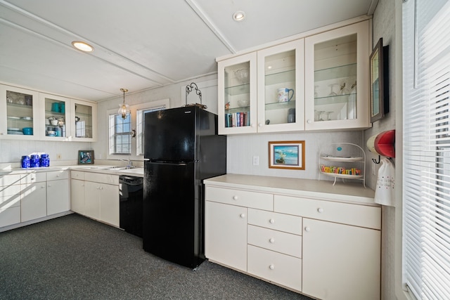 kitchen featuring white cabinets, light countertops, black appliances, and glass insert cabinets