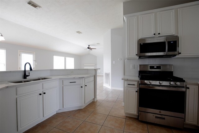 kitchen with a ceiling fan, visible vents, appliances with stainless steel finishes, a sink, and light tile patterned floors
