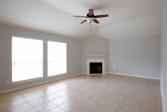unfurnished living room with light tile patterned floors, a wealth of natural light, a ceiling fan, and lofted ceiling