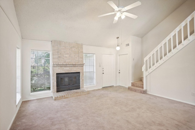 24203 Landing Way Dr, Spring, TX 77373 - unfurnished living room with carpet flooring, stairway, a fireplace, a ceiling fan, and baseboards