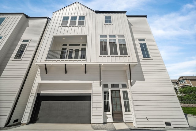 1177 W 19th St, Houston, TX 77008 - view of front of home with a balcony, board and batten siding, an attached garage, and fence
