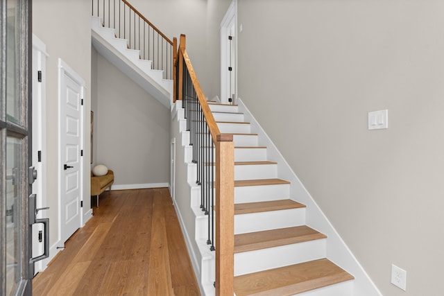 1177 W 19th St, Houston, TX 77008 - stairs with baseboards, wood-type flooring, and a towering ceiling