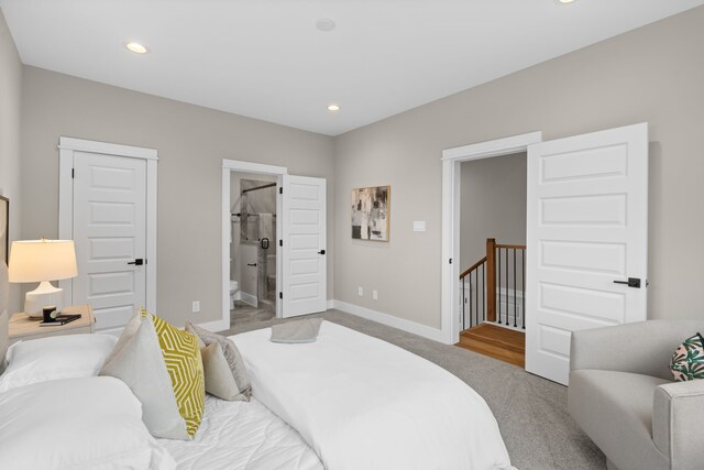 1177 W 19th St, Houston, TX 77008 - carpeted bedroom with connected bathroom, baseboards, and recessed lighting