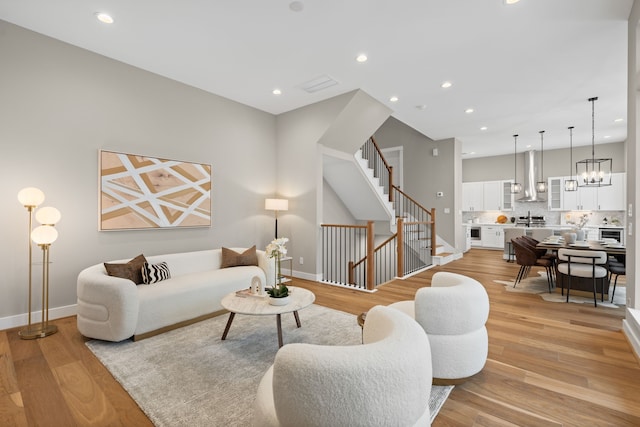 1177 W 19th St, Houston, TX 77008 - living area featuring stairway, light wood-style flooring, baseboards, and recessed lighting