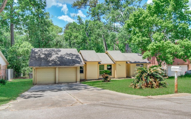 12728 Hollandale Dr, Houston, TX 77082 - view of front facade with an attached garage, driveway, and a shingled roof