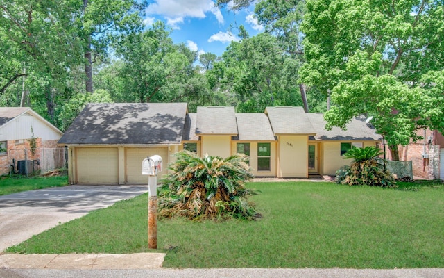 12728 Hollandale Dr, Houston, TX 77082 - view of front facade featuring a garage, driveway, and a shingled roof