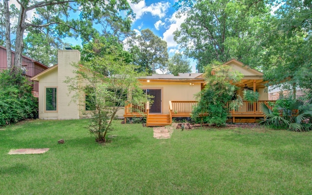 12728 Hollandale Dr, Houston, TX 77082 - rear view of property with ceiling fan, a yard, a wooden deck, and a chimney