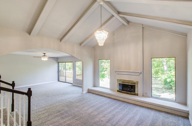12728 Hollandale Dr, Houston, TX 77082 - unfurnished living room featuring a glass covered fireplace, carpet flooring, beamed ceiling, high vaulted ceiling, and arched walkways
