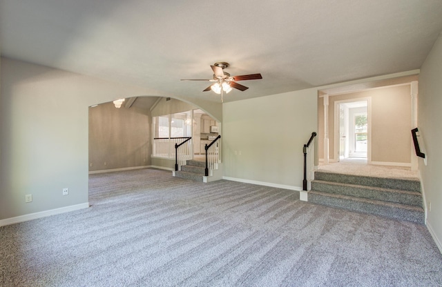 12728 Hollandale Dr, Houston, TX 77082 - unfurnished living room featuring stairway, arched walkways, a ceiling fan, and carpet flooring