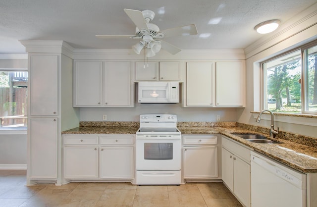 12728 Hollandale Dr, Houston, TX 77082 - kitchen with white appliances, plenty of natural light, white cabinets, and ceiling fan