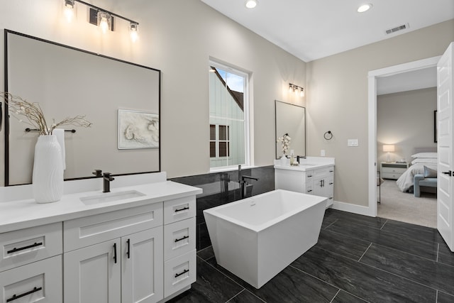 1193 W 19th St, Houston, TX 77008 - full bath featuring two vanities, recessed lighting, a freestanding bath, ensuite bathroom, and baseboards