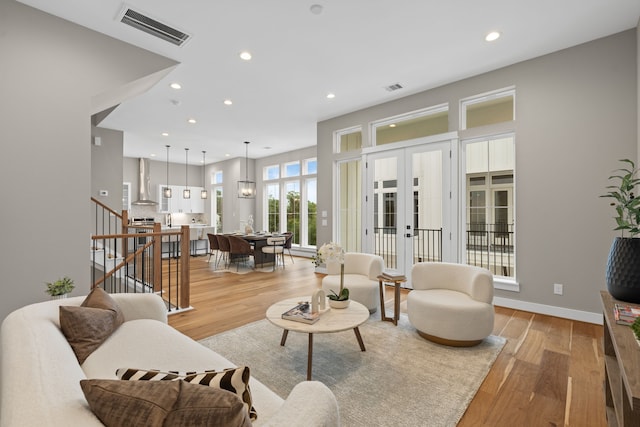 1193 W 19th St, Houston, TX 77008 - living room featuring light wood-style flooring, french doors, recessed lighting, stairway, and baseboards