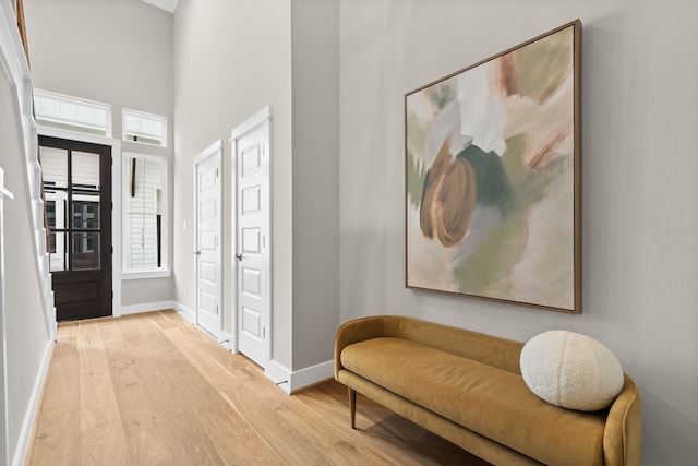 1193 W 19th St, Houston, TX 77008 - entryway featuring light wood-type flooring, baseboards, and a towering ceiling