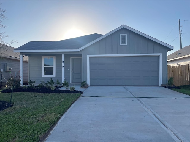 single story home featuring concrete driveway, board and batten siding, an attached garage, fence, and a front yard