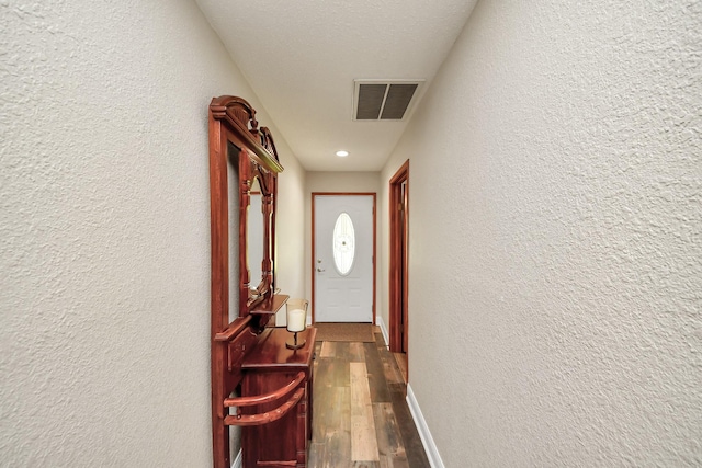 20202 Deer Run Rd, Damon, TX 77430 - hallway featuring visible vents, a textured wall, dark wood-style flooring, and baseboards