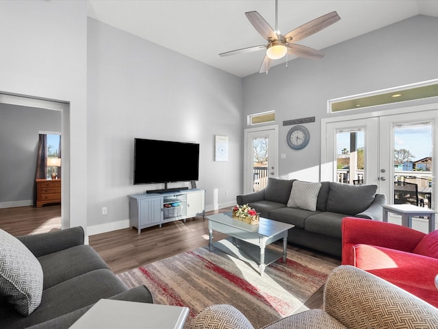 living area featuring french doors, high vaulted ceiling, baseboards, ceiling fan, and wood finished floors