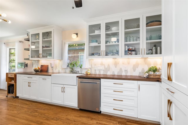 bar featuring a sink, stainless steel dishwasher, backsplash, and a wealth of natural light