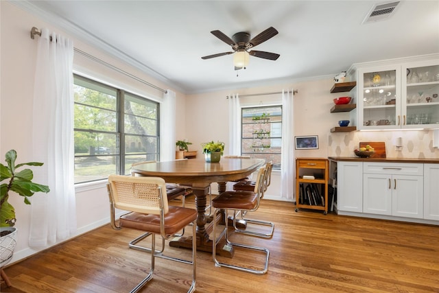 6625 Fairfield St, Houston, TX 77023 - dining area featuring light wood-style flooring, crown molding, healthy amount of natural light, and ceiling fan