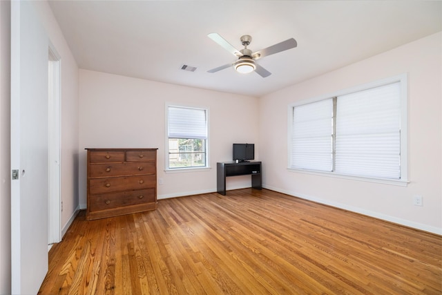 interior space with visible vents, light wood-style floors, ceiling fan, and baseboards