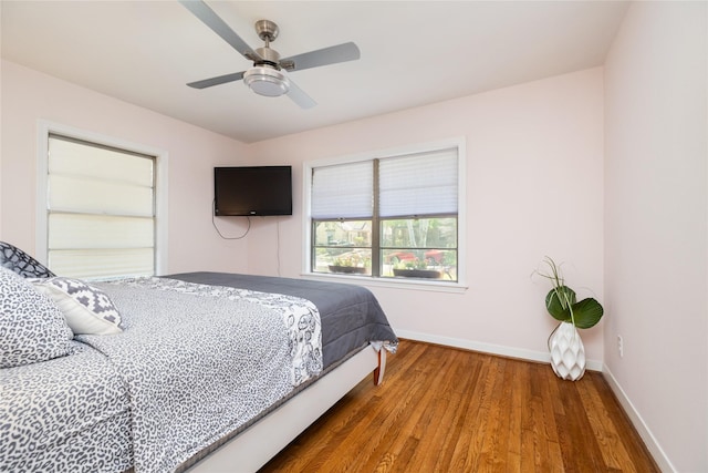 bedroom featuring baseboards, a ceiling fan, and wood finished floors