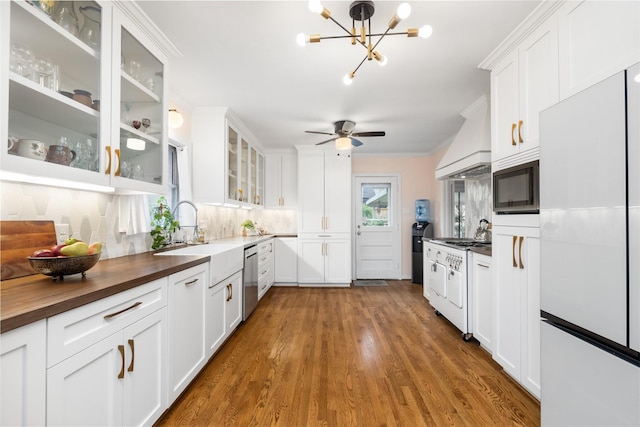 6625 Fairfield St, Houston, TX 77023 - kitchen featuring custom exhaust hood, wood counters, white appliances, white cabinets, and ornamental molding