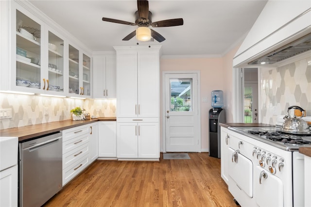 kitchen featuring dishwasher, light wood-style floors, ventilation hood, white cabinetry, and backsplash