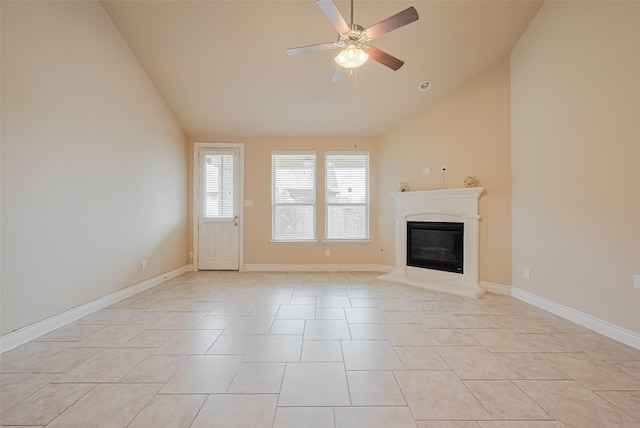 unfurnished living room featuring high vaulted ceiling, ceiling fan, a glass covered fireplace, light tile patterned flooring, and baseboards