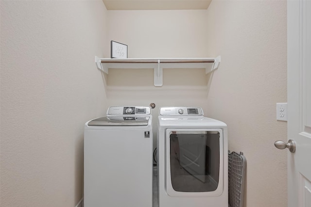washroom featuring washer and dryer and laundry area