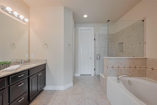 full bath featuring baseboards, a shower stall, vanity, tile patterned floors, and a garden tub