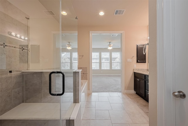 bathroom with vanity, a stall shower, visible vents, a bath, and ceiling fan