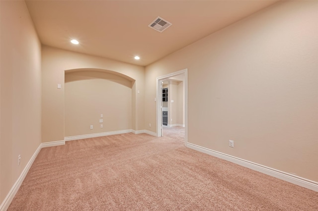 spare room with visible vents, baseboards, recessed lighting, and light colored carpet