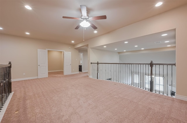 spare room with ceiling fan, recessed lighting, light colored carpet, and baseboards
