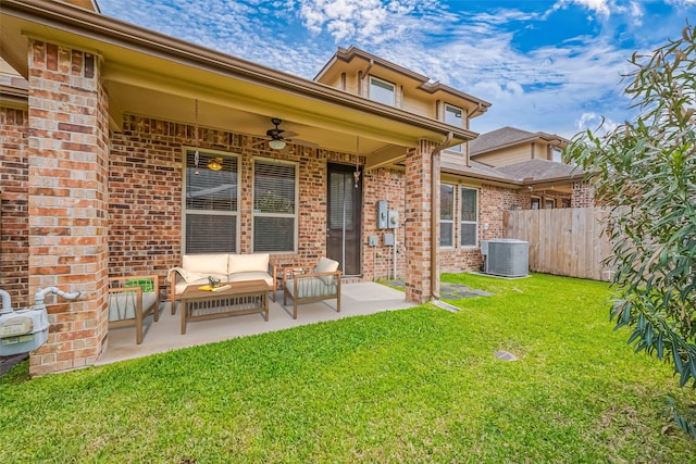 back of house featuring an outdoor hangout area, a yard, a patio area, fence, and brick siding