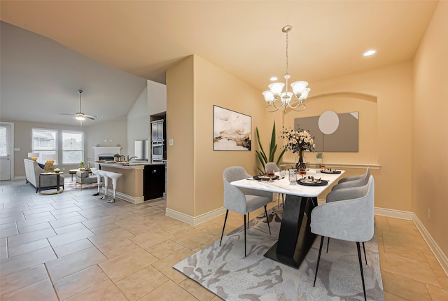 dining space with ceiling fan with notable chandelier, light tile patterned floors, recessed lighting, lofted ceiling, and baseboards