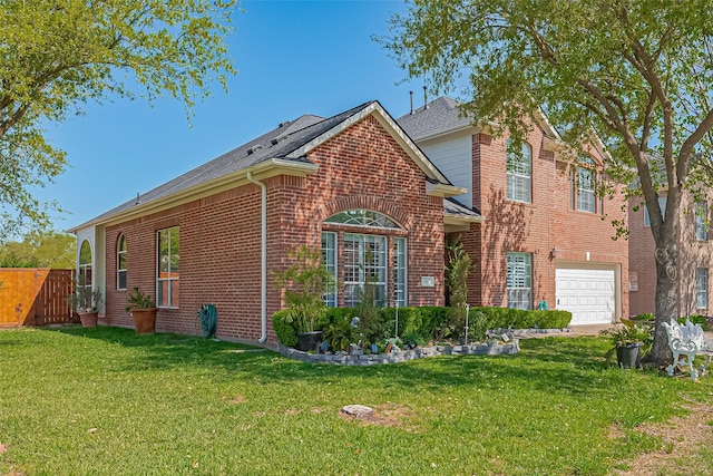 view of side of property featuring roof with shingles, a garage, brick siding, fence, and a yard
