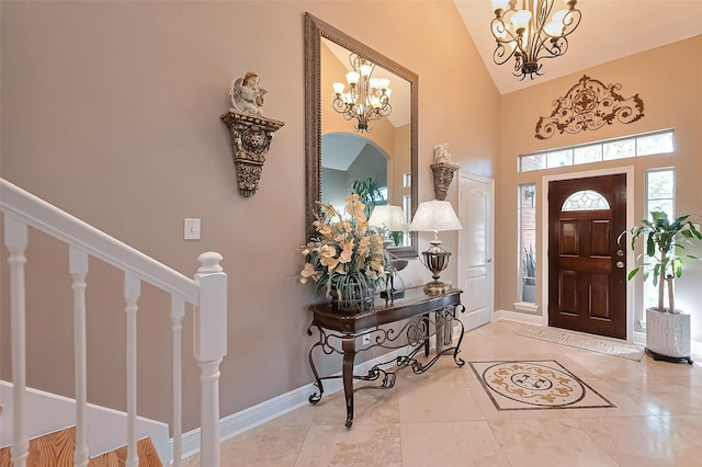 tiled foyer featuring an inviting chandelier, high vaulted ceiling, baseboards, and stairs