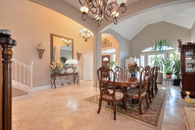 dining room featuring light tile patterned flooring, arched walkways, high vaulted ceiling, a chandelier, and stairway