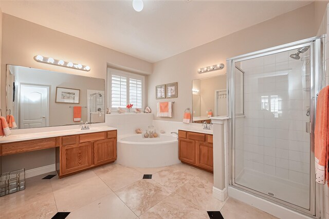 full bath with tile patterned flooring, a stall shower, a garden tub, and two vanities