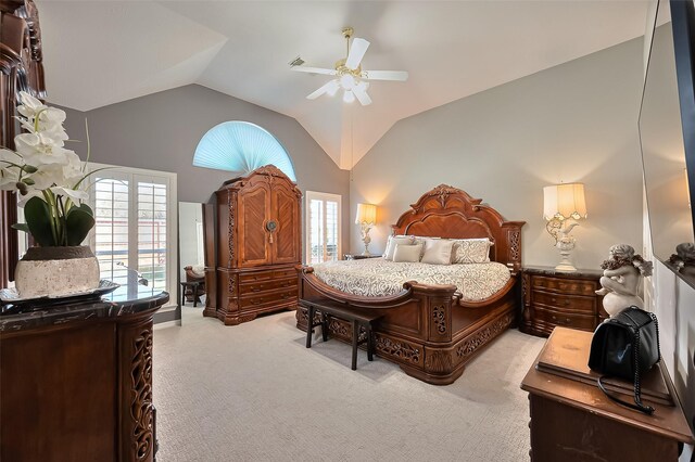 carpeted bedroom with ceiling fan, lofted ceiling, and multiple windows