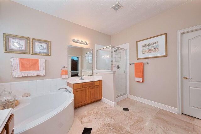 full bath with vanity, visible vents, a garden tub, and a stall shower