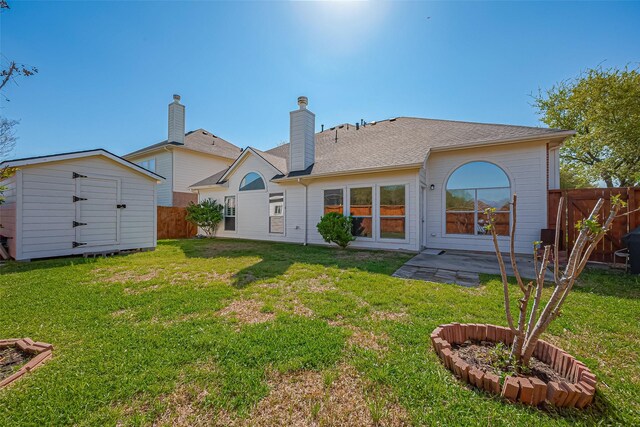 rear view of property with a storage shed, a fenced backyard, a patio area, an outdoor structure, and a yard