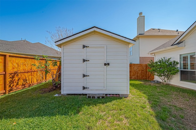 view of shed with a fenced backyard