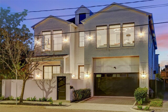 1810 Dunlavy St, Houston, TX 77006 - contemporary house featuring brick siding, an attached garage, and decorative driveway