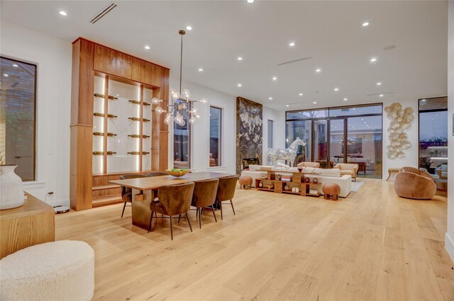 1810 Dunlavy St, Houston, TX 77006 - dining area with light wood finished floors, recessed lighting, and a chandelier